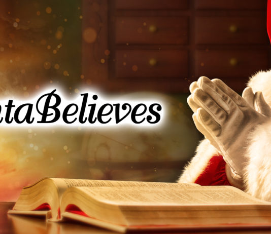 Santa praying over open Bible.